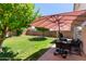 Lush backyard with a spacious patio, mature tree providing shade, perfect for outdoor relaxation at 5018 W Wikieup Ln, Glendale, AZ 85308