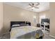 Inviting bedroom featuring carpet, fan and two windows at 5018 W Wikieup Ln, Glendale, AZ 85308