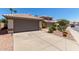 Lovely home with a well-kept front yard and a convenient two-car garage, complemented by desert landscaping at 5018 W Wikieup Ln, Glendale, AZ 85308