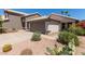 Beautiful exterior view featuring an attached two-car garage, desert landscaping, and charming curb appeal at 5018 W Wikieup Ln, Glendale, AZ 85308