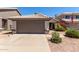 Charming home featuring a well-kept yard with a spacious driveway and an attached two-car garage at 5018 W Wikieup Ln, Glendale, AZ 85308
