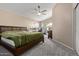 Spacious main bedroom with neutral walls, carpet flooring, fan and access to the backyard at 5018 W Wikieup Ln, Glendale, AZ 85308
