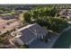 Expansive aerial view of a desert home with lush landscaping and a well-maintained front yard in a quiet neighborhood at 5102 S Peachwood Dr, Gilbert, AZ 85298