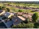 High aerial view of a golf course community home featuring a backyard pool and lush green golf course views at 5102 S Peachwood Dr, Gilbert, AZ 85298