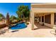 Great outdoor area with a pool, patio, lush green trees, and a built-in grill at 5102 S Peachwood Dr, Gilbert, AZ 85298