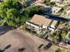 Aerial view of a backyard with a covered patio, pool, and a spacious fenced-in yard with desert landscaping at 5102 S Peachwood Dr, Gilbert, AZ 85298