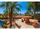 Backyard features a dining set and lush palms at 5102 S Peachwood Dr, Gilbert, AZ 85298