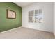 Cozy bedroom featuring natural light through shuttered windows and green accent wall at 5102 S Peachwood Dr, Gilbert, AZ 85298