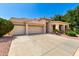 Attractive single-story home featuring a large driveway and a three-car garage at 5102 S Peachwood Dr, Gilbert, AZ 85298