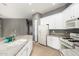 Well-lit kitchen with island, sleek appliances, and tile flooring at 5102 S Peachwood Dr, Gilbert, AZ 85298