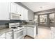 Bright kitchen featuring white cabinets, marble countertops, and modern appliances at 5102 S Peachwood Dr, Gilbert, AZ 85298
