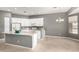Bright kitchen featuring white cabinets, a center island, and tile flooring at 5102 S Peachwood Dr, Gilbert, AZ 85298