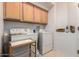 Convenient laundry room with washer, dryer, and upper cabinets at 5102 S Peachwood Dr, Gilbert, AZ 85298