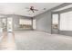 Bright living room with carpet, ceiling fan, and multiple windows for ample natural light at 5102 S Peachwood Dr, Gilbert, AZ 85298