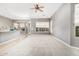Spacious living area offers carpet, abundant windows, and neutral gray walls at 5102 S Peachwood Dr, Gilbert, AZ 85298