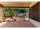 Covered patio with outdoor grill and seating area overlooks a lush backyard at 5102 S Peachwood Dr, Gilbert, AZ 85298