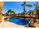Backyard pool features refreshing water, rock features and plenty of vegetation at 5102 S Peachwood Dr, Gilbert, AZ 85298