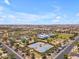 An aerial shot shows tennis courts and a community recreation center within a sprawling residential area at 5637 S Parrish --, Mesa, AZ 85212