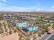 Aerial view of a resort-style pool with palm trees, water slides, and plenty of lounging space at 5637 S Parrish --, Mesa, AZ 85212
