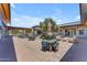 Charming courtyard with patio seating, greenery, and umbrellas, offering a relaxing outdoor space at 5637 S Parrish --, Mesa, AZ 85212