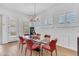 Bright dining room with a glass table, red chairs, and views of the pool at 5637 S Parrish --, Mesa, AZ 85212