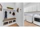Functional mudroom with built-in bench seating and storage, leading to a laundry room at 5637 S Parrish --, Mesa, AZ 85212