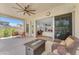 Inviting covered patio with a ceiling fan, comfortable seating, and a view of the house interior at 5637 S Parrish --, Mesa, AZ 85212