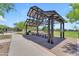 Shaded picnic area with tables and benches, surrounded by lush greenery, perfect for community gatherings at 5637 S Parrish --, Mesa, AZ 85212