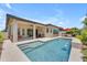 Backyard pool with waterfall feature, patio seating, and lush landscaping at 5637 S Parrish --, Mesa, AZ 85212