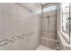 Walk-in shower featuring neutral-tone tile, dual shower heads, and a bench at 5637 S Parrish --, Mesa, AZ 85212