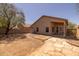 Spacious backyard with a stone walkway and a covered patio area at 718 E Devon Dr, Gilbert, AZ 85296