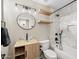 Updated bathroom with a glass vessel sink, floating shelves, and shower at 718 E Devon Dr, Gilbert, AZ 85296