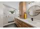 Well-lit bathroom features an updated walk-in shower, double vanity and modern finishes at 718 E Devon Dr, Gilbert, AZ 85296