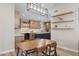 An open dining area with views to the kitchen, with open shelves and updated lighting at 718 E Devon Dr, Gilbert, AZ 85296