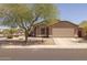 Charming single-story home featuring a landscaped front yard and a two-car garage at 718 E Devon Dr, Gilbert, AZ 85296
