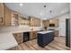 Spacious kitchen featuring custom cabinets, mosaic backsplash, and a stylish center island at 718 E Devon Dr, Gilbert, AZ 85296