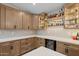 The kitchen features custom cabinets, quartz countertops, a beverage fridge and a lit shelving display area at 718 E Devon Dr, Gilbert, AZ 85296