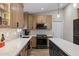 Modern kitchen featuring granite countertops, stainless appliances, and custom lighting at 718 E Devon Dr, Gilbert, AZ 85296