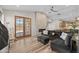 A cozy living room featuring a brick fireplace, hardwood floors, and sliding glass doors at 718 E Devon Dr, Gilbert, AZ 85296