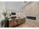 Modern living room features a decorative fireplace, hardwood floors and a large-screen TV at 718 E Devon Dr, Gilbert, AZ 85296