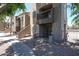 Apartment building with balconies and stucco exterior, accented with lush greenery at 747 S Extension Rd # 115, Mesa, AZ 85210