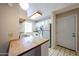 Well-lit kitchen with stainless steel appliances and wood countertops, creating a warm and inviting atmosphere at 747 S Extension Rd # 115, Mesa, AZ 85210