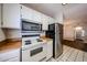 Eat-in kitchen featuring white cabinets, stainless steel appliances, and tile floors at 747 S Extension Rd # 115, Mesa, AZ 85210