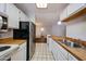 Kitchen with white cabinets, wood countertop and stainless steel appliances at 747 S Extension Rd # 115, Mesa, AZ 85210