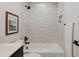 Modern bathroom featuring a shower over the tub with white tile and matte black hardware at 7620 N 12Th Pl, Phoenix, AZ 85020