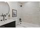Modern bathroom featuring a shower over the tub with white tile and matte black hardware at 7620 N 12Th Pl, Phoenix, AZ 85020