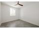 Bright bedroom featuring a large window, tile floors, and ceiling fan at 7620 N 12Th Pl, Phoenix, AZ 85020