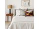 Bright bedroom featuring a modern lamp on a wooden nightstand and stylish decorative pillows at 7620 N 12Th Pl, Phoenix, AZ 85020