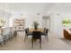 Bright dining area with modern chairs, a wooden table, and an open connection to the kitchen at 7620 N 12Th Pl, Phoenix, AZ 85020