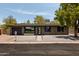 Charming single-story home features a brick exterior, desert landscaping, and a modern front door at 7620 N 12Th Pl, Phoenix, AZ 85020